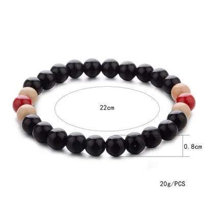 Unisex natural stone bead bracelet with lava stones for essential oils, ethnic style, on a wrist.