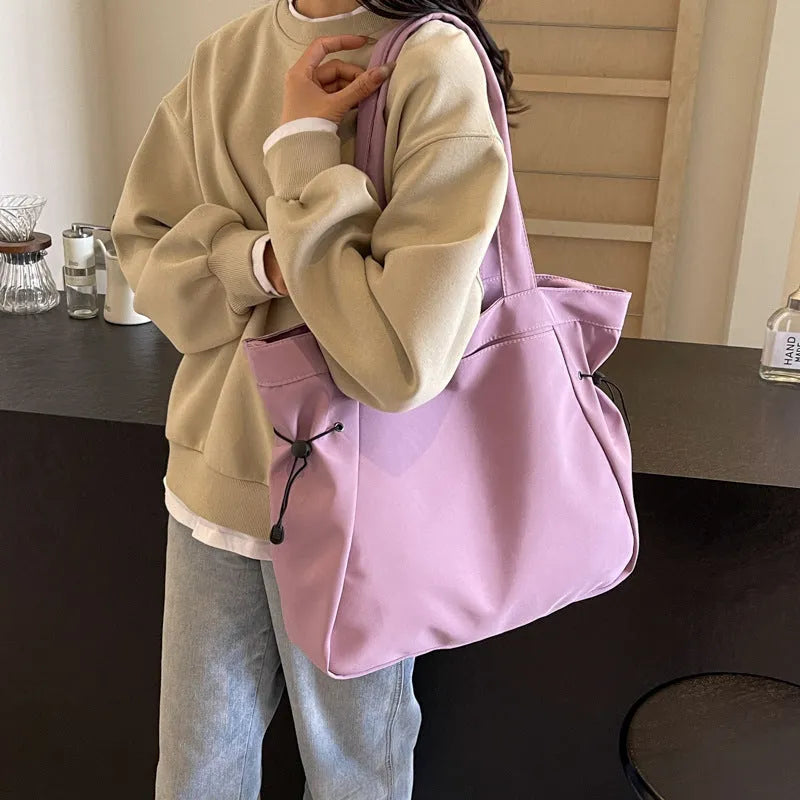Soft Oxford cloth foldable tote bag shown in one of five colours: black, brown, dark grey, light grey, or purple.
