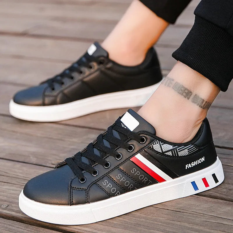 A pair of standard sports shoes shown in a choice of black, grey, or white colour.