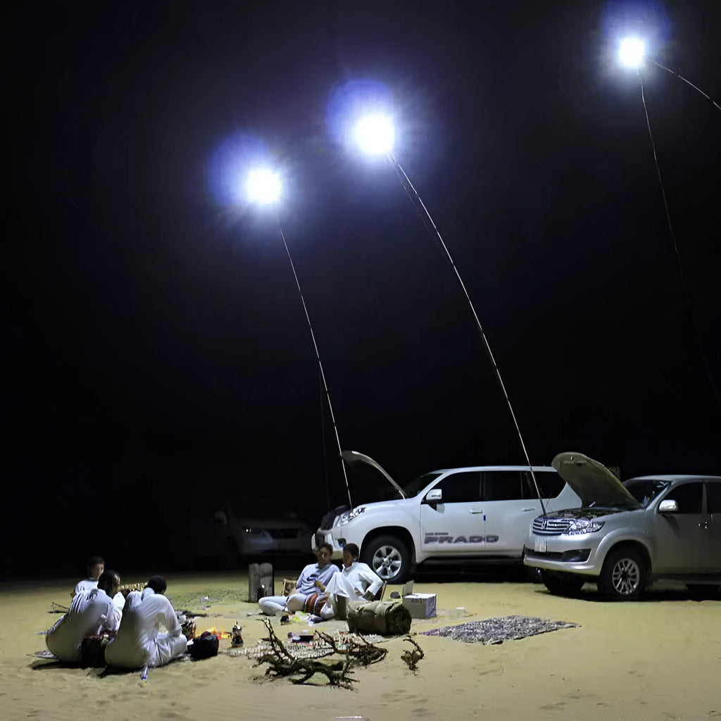 White LED fishing rod light unit with remote control next to extended telescopic pole