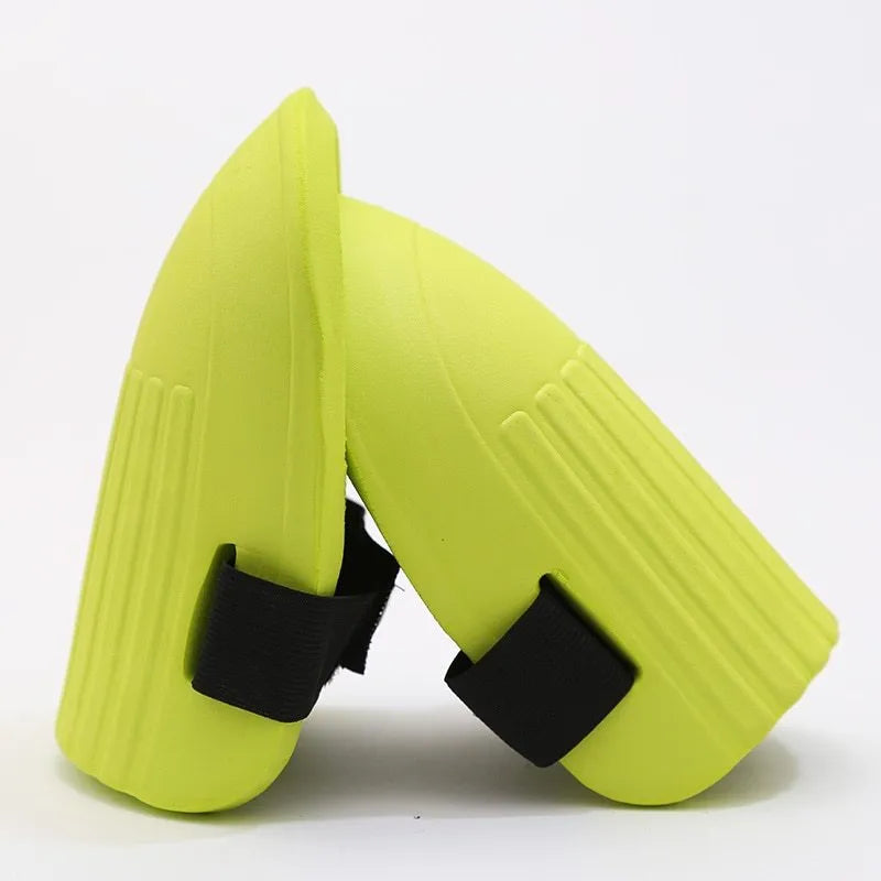 A pair of black EVA foam knee pads showing their rectangular shape and thick profile for knee protection.
