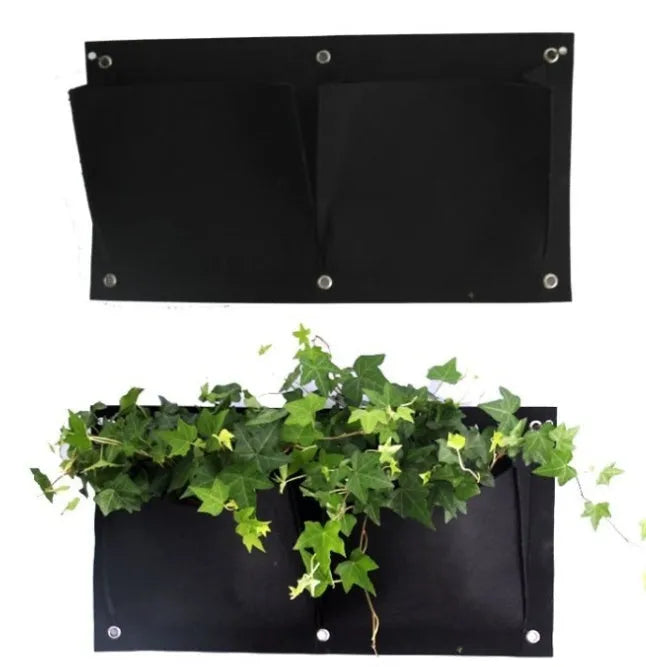 Green felt vertical wall planter with multiple planting pockets hung on an outdoor fence