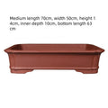 Large rectangular purple clay bonsai flowerpot showing handmade texture and scale.