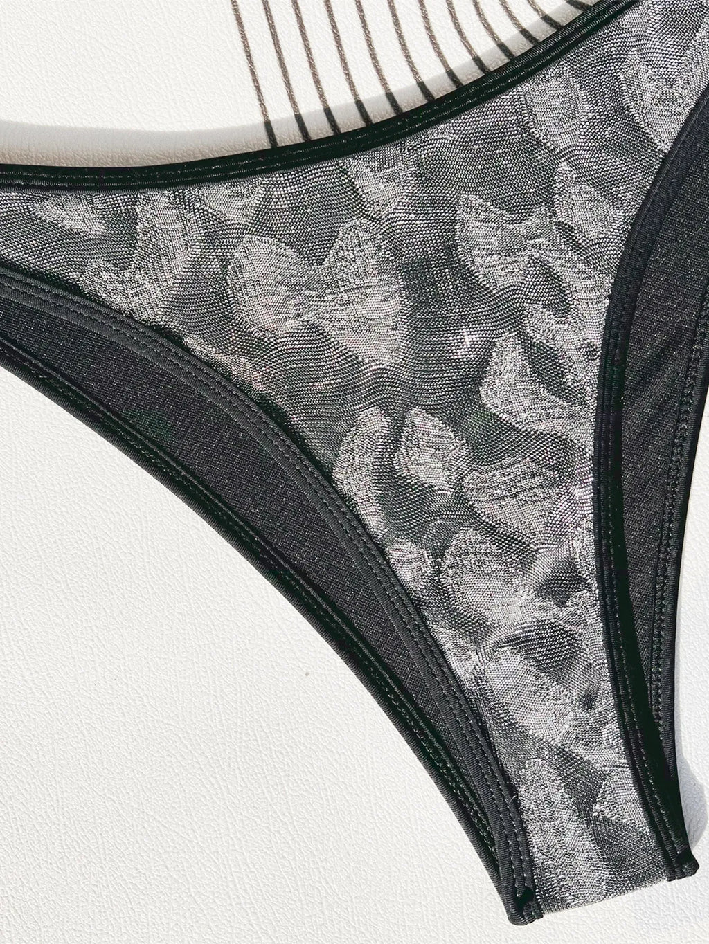 Black ladies bikini swimsuit with stitrap design on a mannequin.
