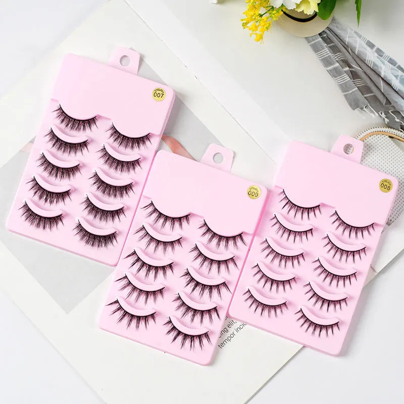 Five pairs of wispy manga-style false eyelashes on a plastic black terrier base for cosplay.