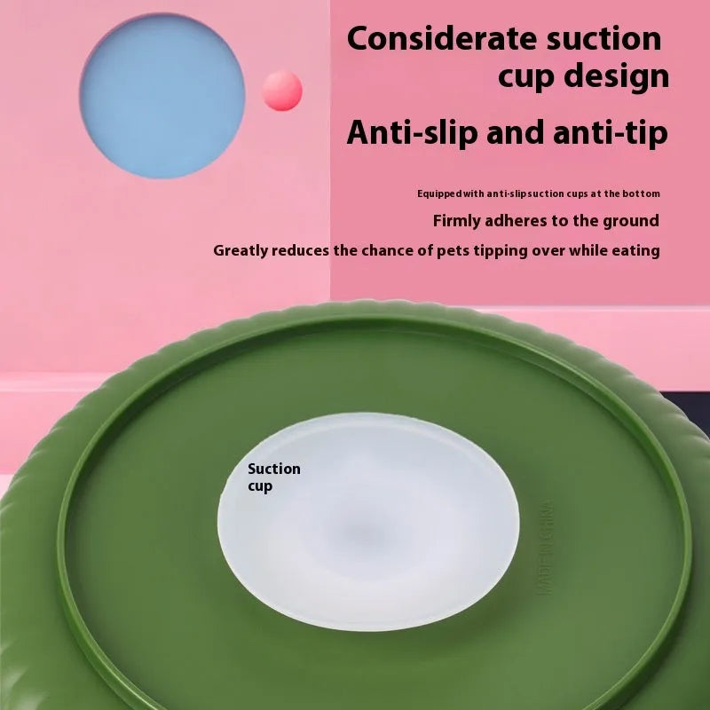 A grey plastic rotating pet bowl with a textured blue silicone slow-feeding mat attached, showing a windmill pattern.