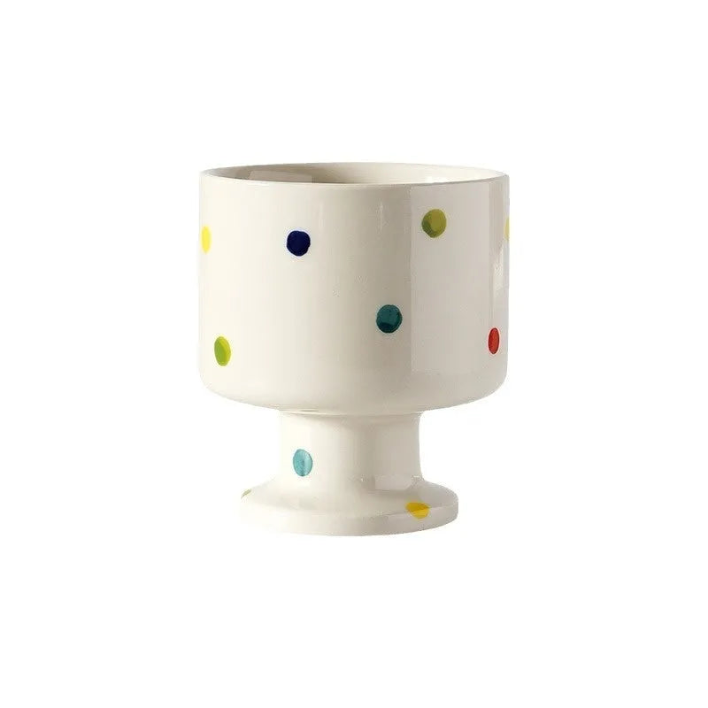 Hand-pinched irregular ceramic mug in a solid colour, shown from the side to display its unique shape.