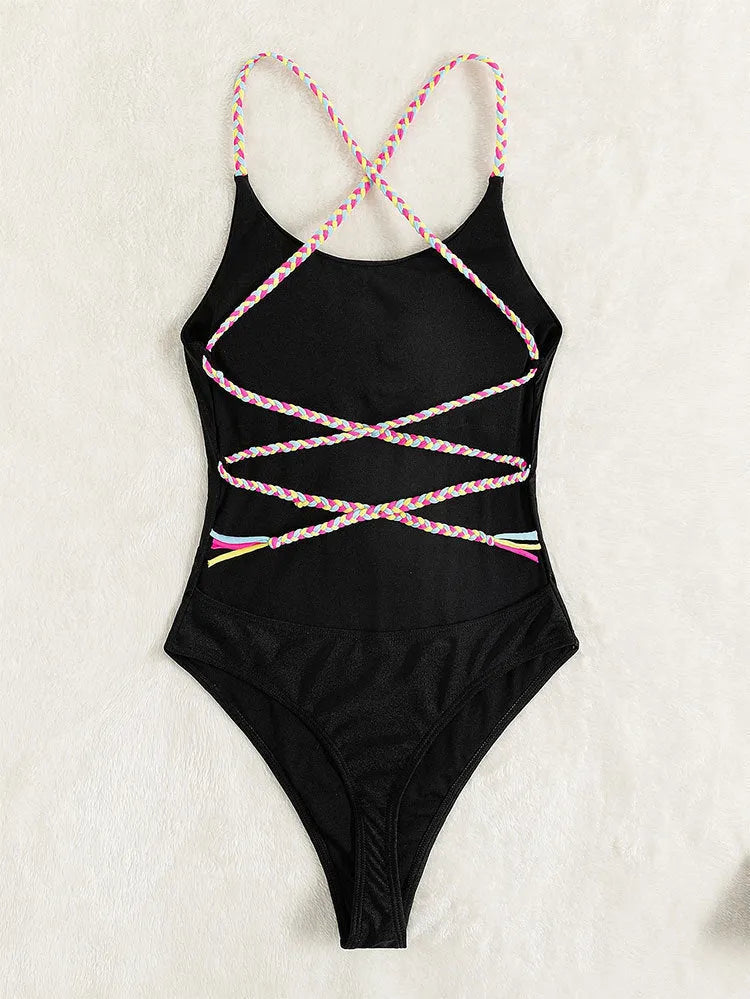 Black backless one-piece swimsuit on a white background