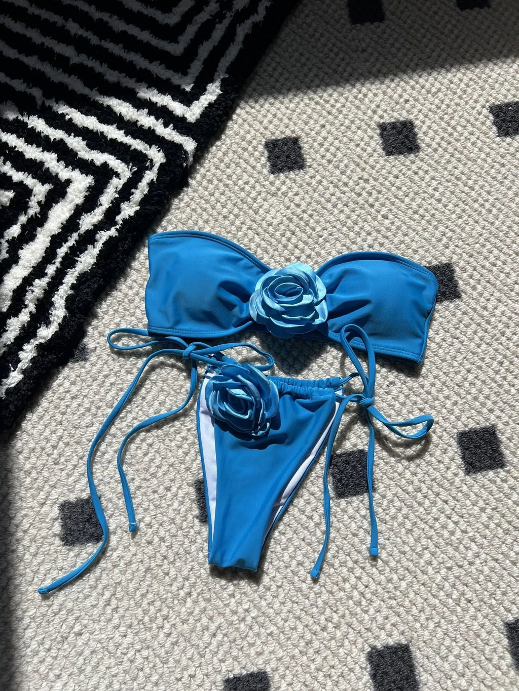 Women's solid colour tube top swimsuit with drawstring straps and briefs style bottom.