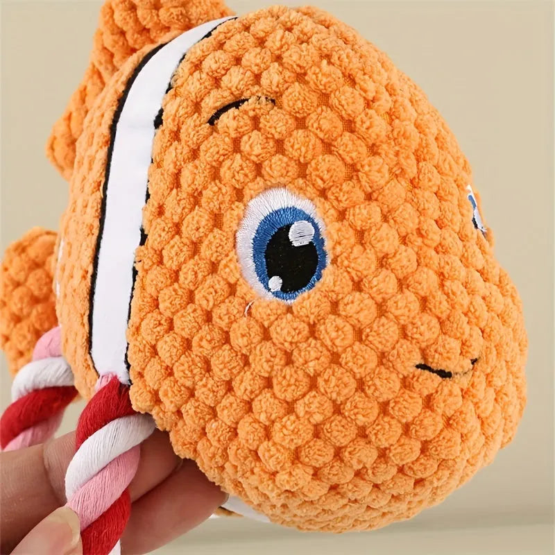 Turtle shaped plush dog toy with knotted rope limbs and squeaker in grey green orange colours
