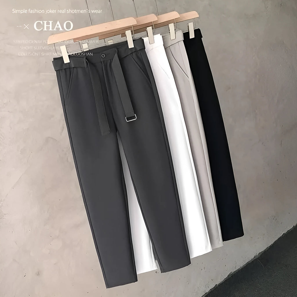 Boys slim straight-leg wool trousers in tapered cut, shown in black, on a hanger.