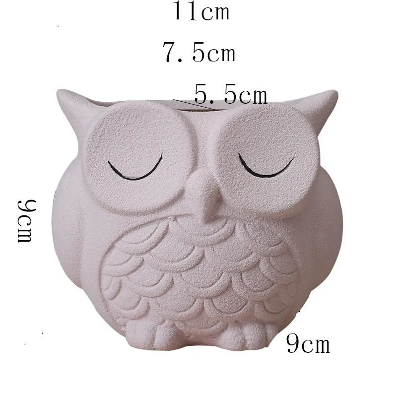 Handmade frosted ceramic owl planter for small succulents, shown in light pink.