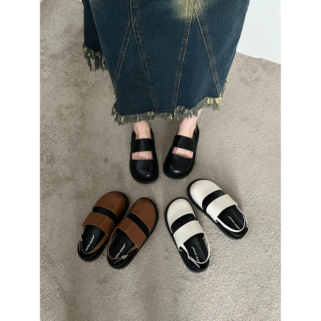Retro brown platform sandals with a single ankle strap buckle and closed round toe.