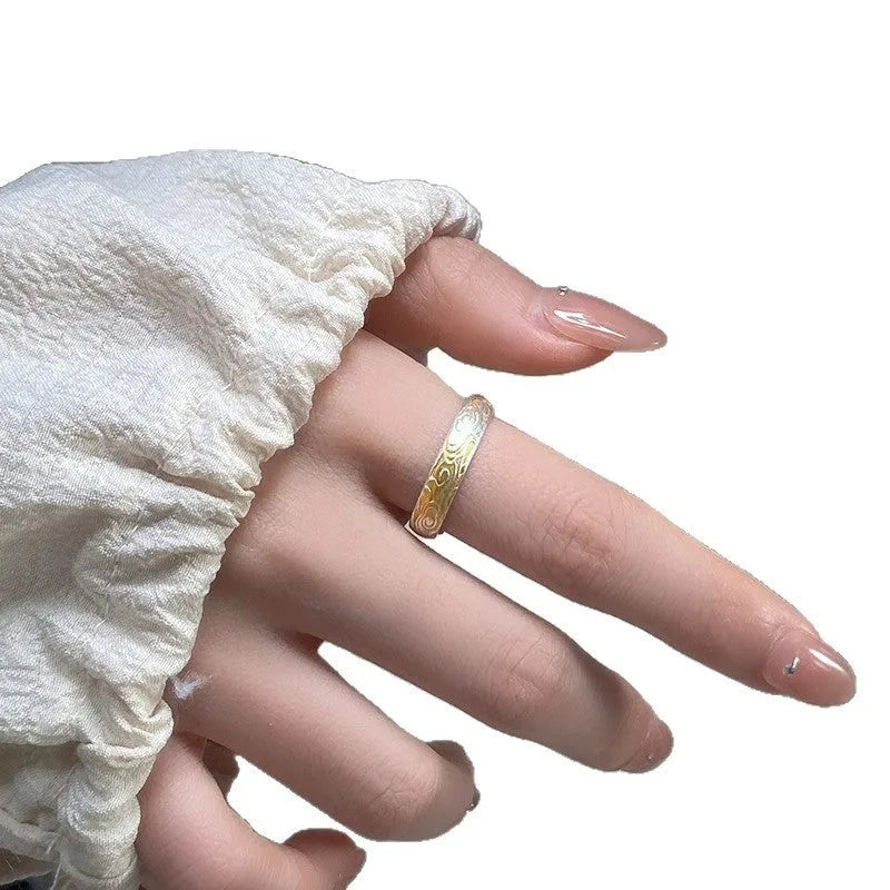 Open-mouth geometric ring with engraved xiangyun pattern in electroplated white copper showing silver and gold finish options