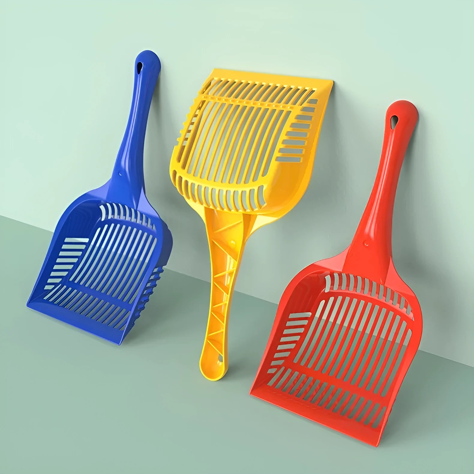 Red, yellow and blue plastic cat litter scoops in small and medium sizes