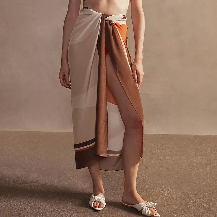 Women's dotted one-piece swimsuit with a matching wrap skirt laid flat.