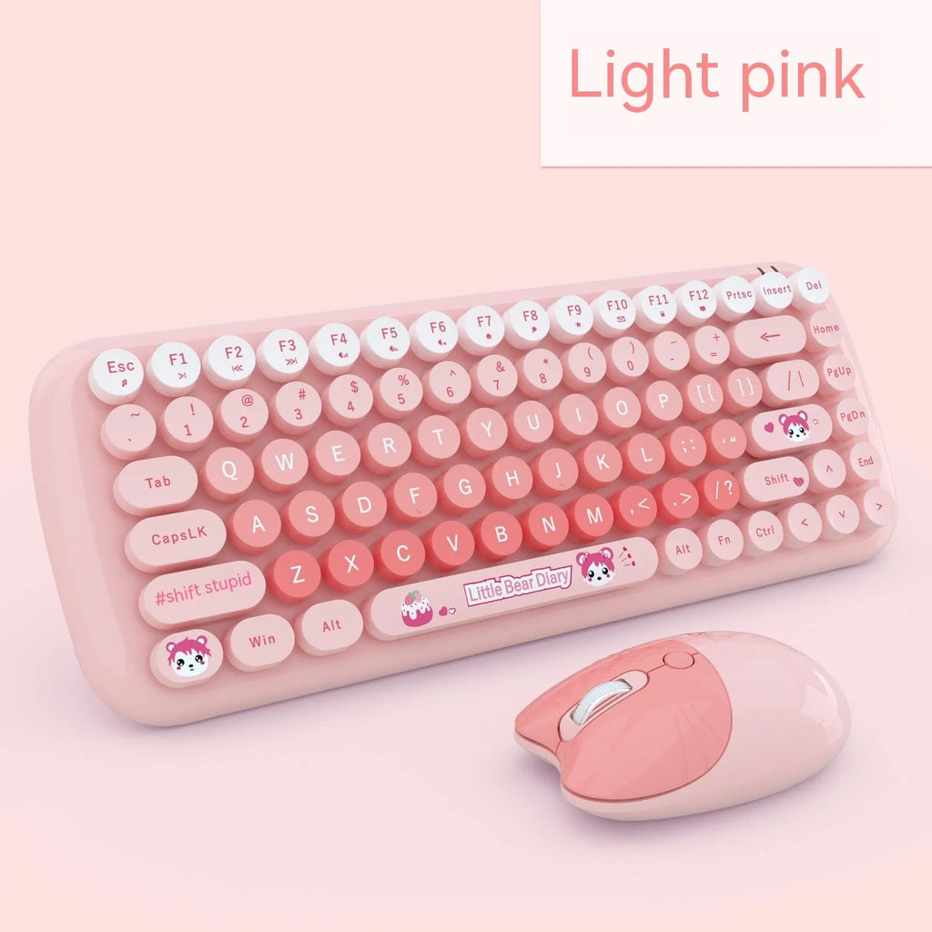 Candy pink wireless keyboard and mouse set with miniature cartoon design on a desk.