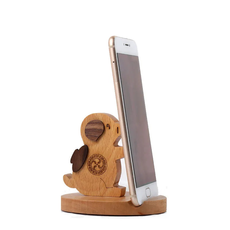 Beech wood mobile phone holder with resin animal decoration and custom lettering on coin back.