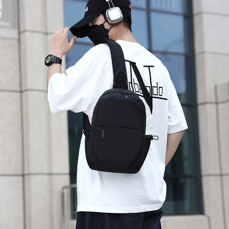 Men's grey waterproof chest bag showing front compartment with 33cm height measurement