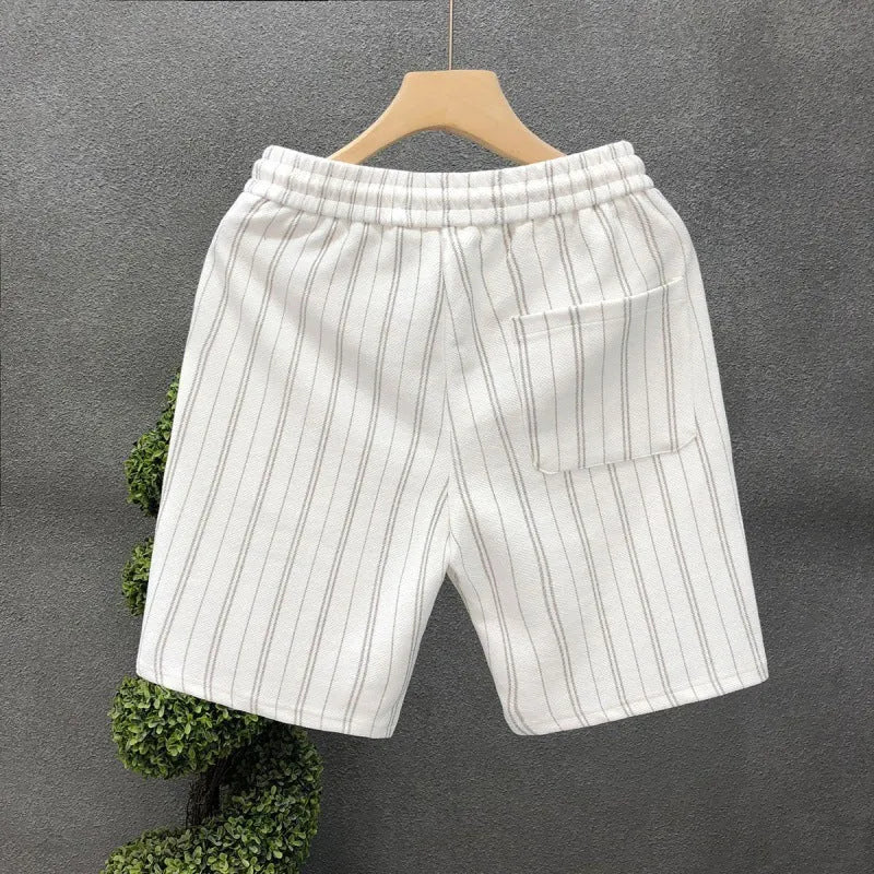 Men's black and white striped casual shorts with elastic waistband showing straight-leg design
