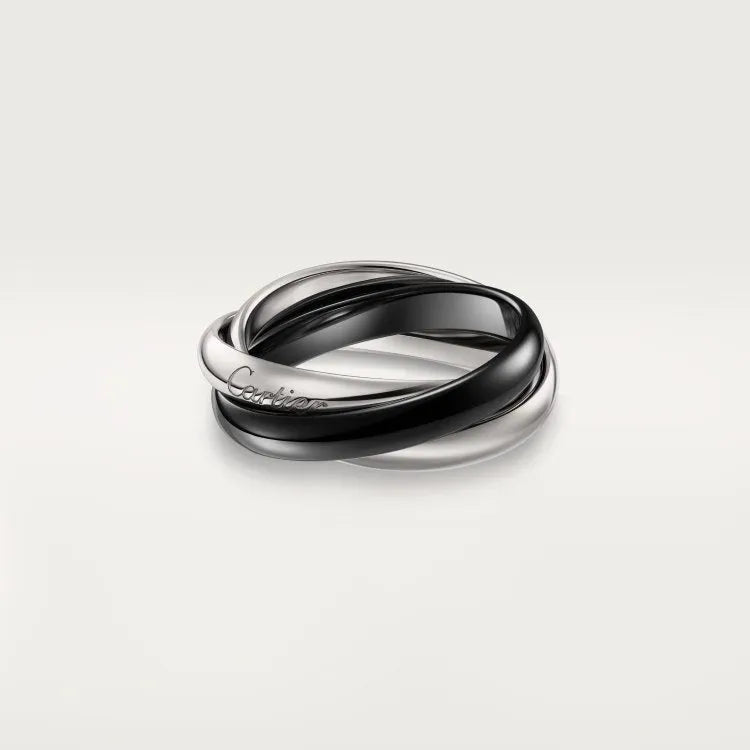 A pair of matching sterling silver U-shaped geometric couple rings with diamond accents on a black background.