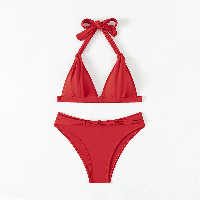 Red women's lace-up halterneck bikini set with matching split beach shorts.