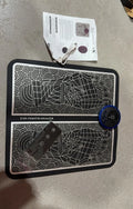 Pulse Micro-current foot massage cushion with wireless remote control on leather surface