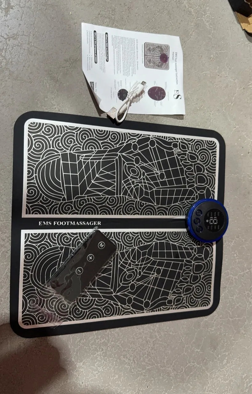 Pulse Micro-current foot massage cushion with wireless remote control on leather surface