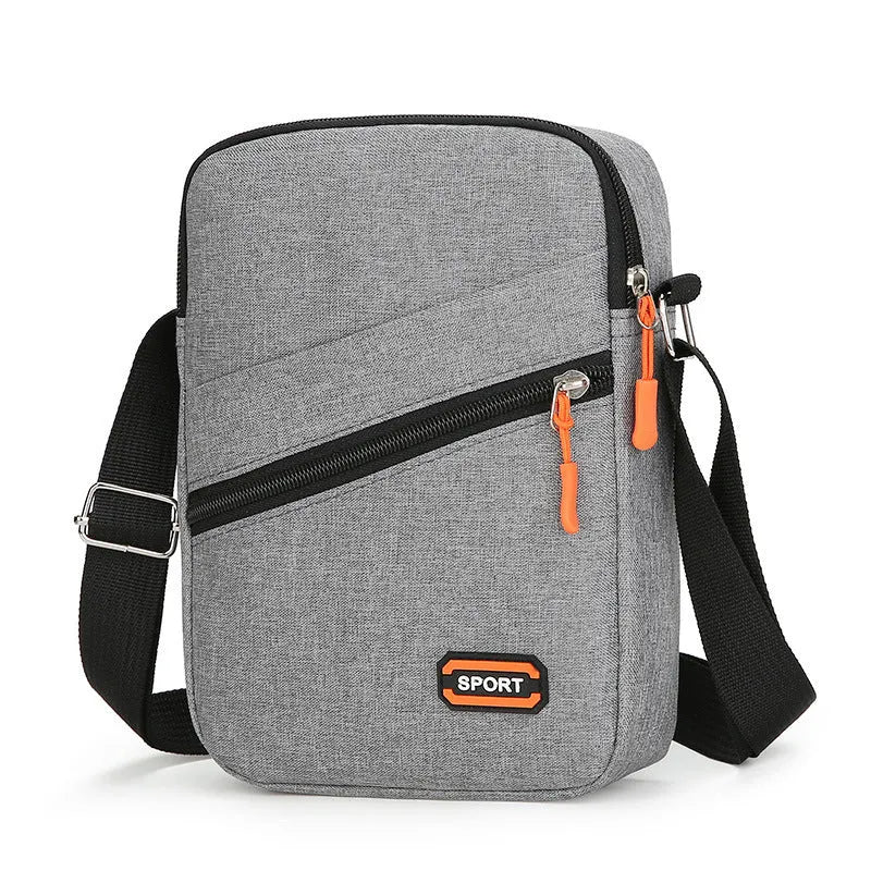 Lightweight solid colour oxford cloth crossbody commuter bag in black, navy, or silver grey.