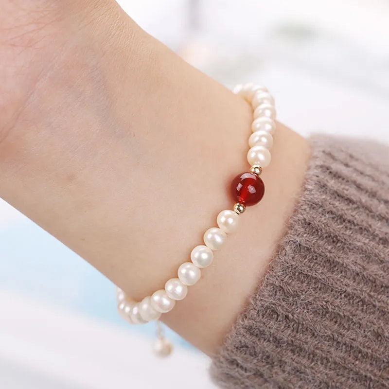Chinese style handmade glass bead bracelet with bamboo joint elements on a white background.