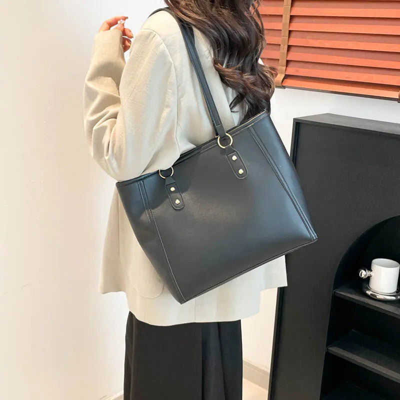 Large capacity PU tote bag in horizontal square shape with external slit pocket and internal organisation