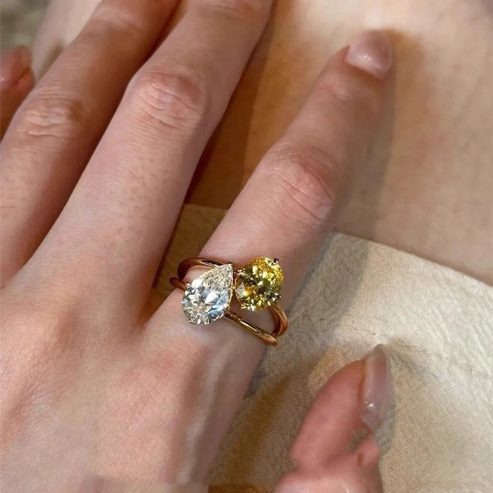 Water drop double Sheng stone copper ring with geometric open design and zircon detailing