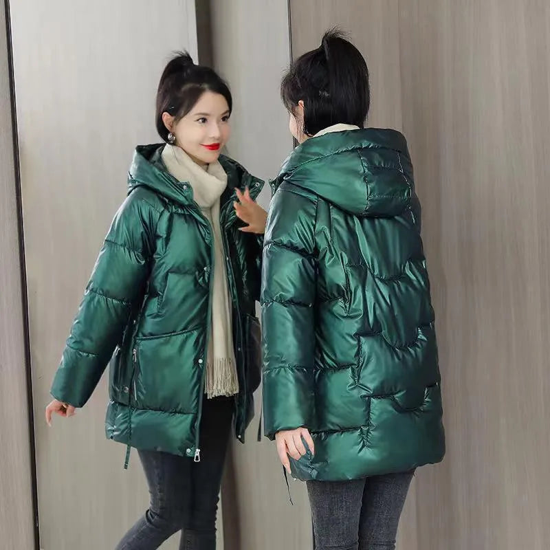 Women's loose thick hooded winter jacket in green, shown with long sleeves and a front zip.