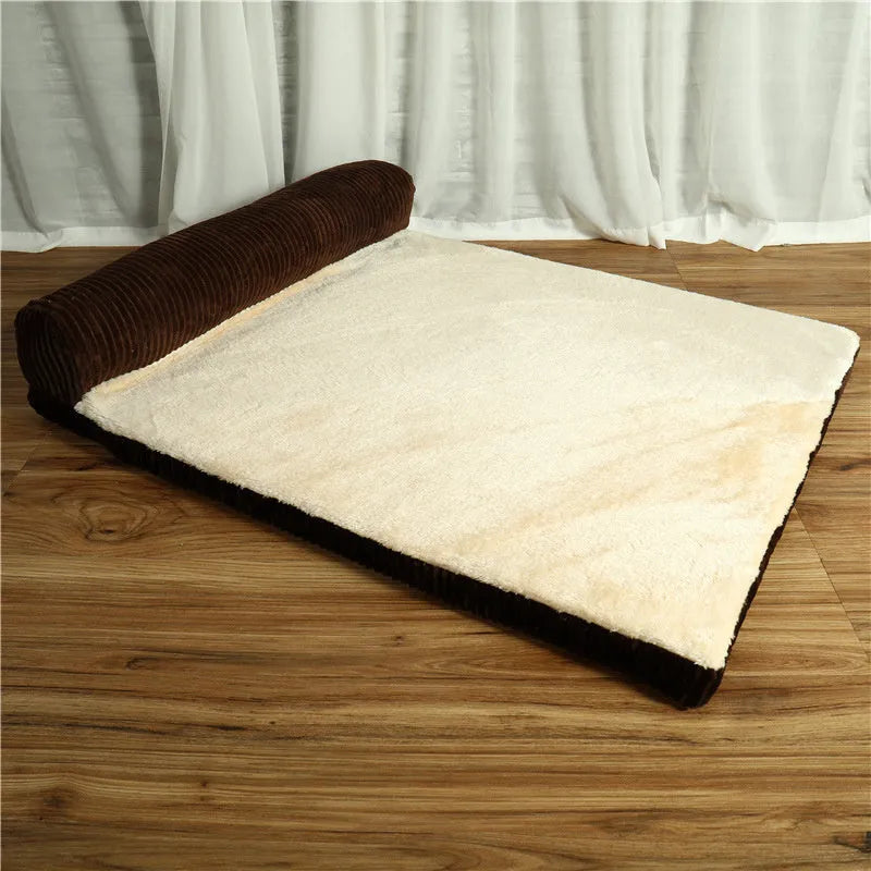 Corduroy dog sofa bed with bolster sides in a grey colour, shown on a wooden floor.