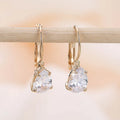 Women's drop-shaped copper earrings with a gemstone inlay, available in gold or platinum colour finish.