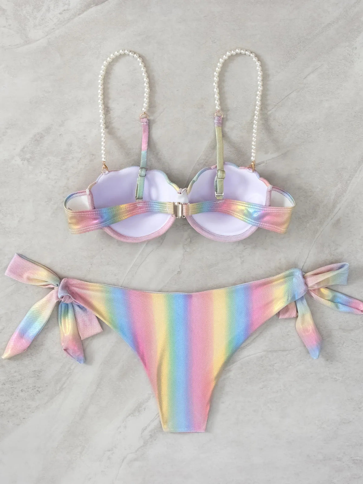 Women's shell rainbow print bikini swimsuit with split tied design on a beach background