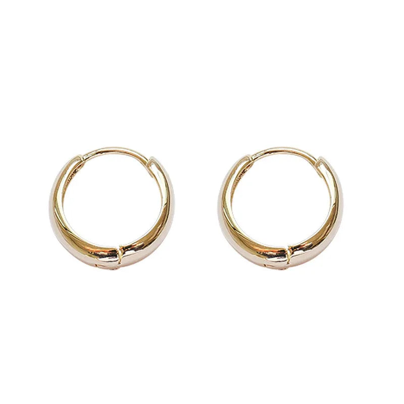 Geometric water drop shaped copper earrings with a minimalist design in a gold electroplated finish.