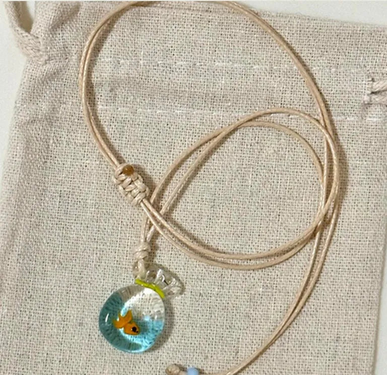 Women's joker charm necklace with coloured glaze pendant on a cotton and linen clavicle chain.