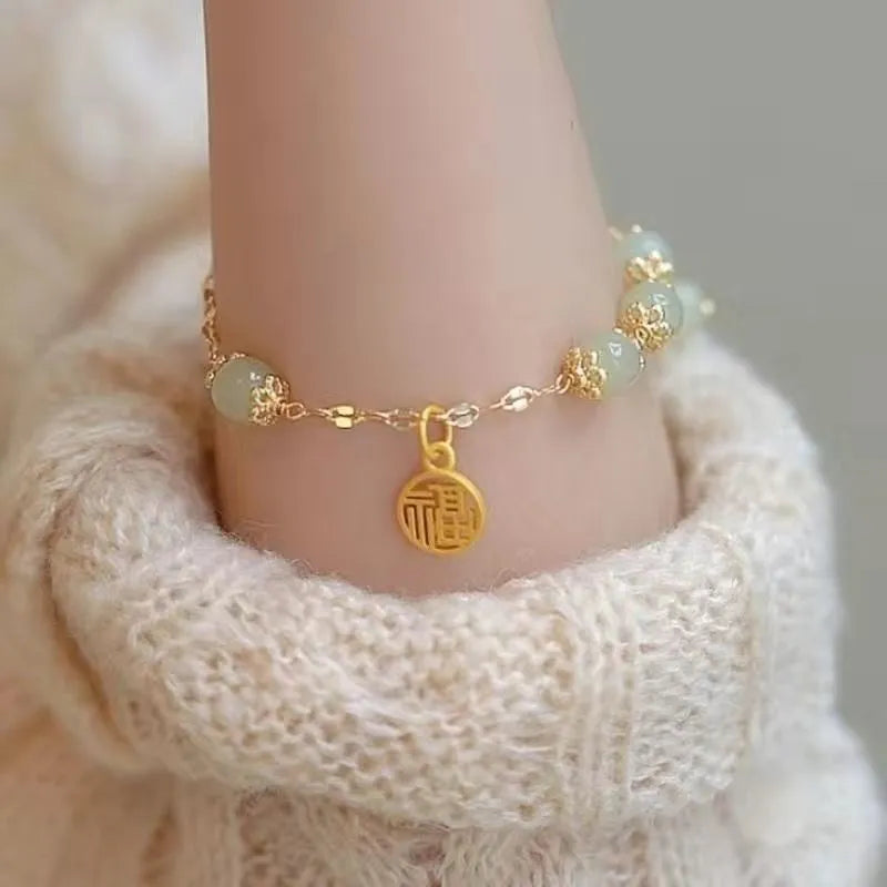 Chinese style handmade glass bead bracelet with bamboo joint elements on a white background.