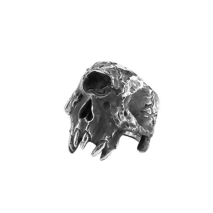 Silver-toned alloy skull ring with a detailed one-eyed design on a black background.