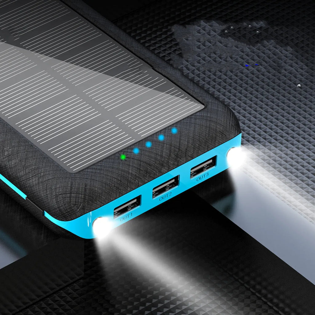 Black portable power bank with Qi wireless charging pad and three USB ports on the side