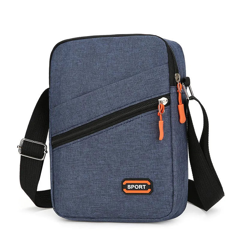 Lightweight solid colour oxford cloth crossbody commuter bag in black, navy, or silver grey.