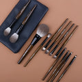 12-piece makeup brush set with wooden handles and a grey PU case