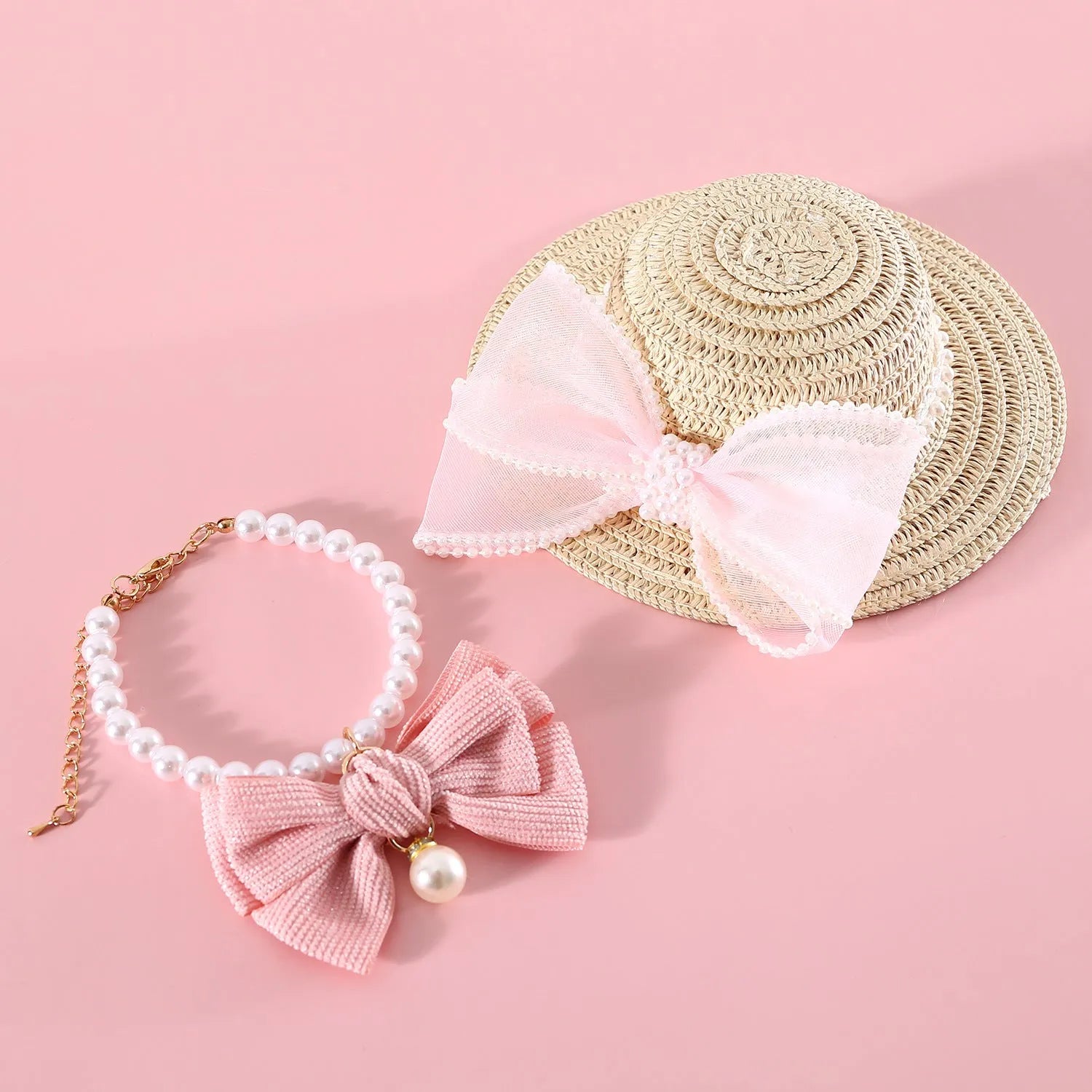Woven straw hat for cats with pearl butterfly bow in princess style, shown in pink colour