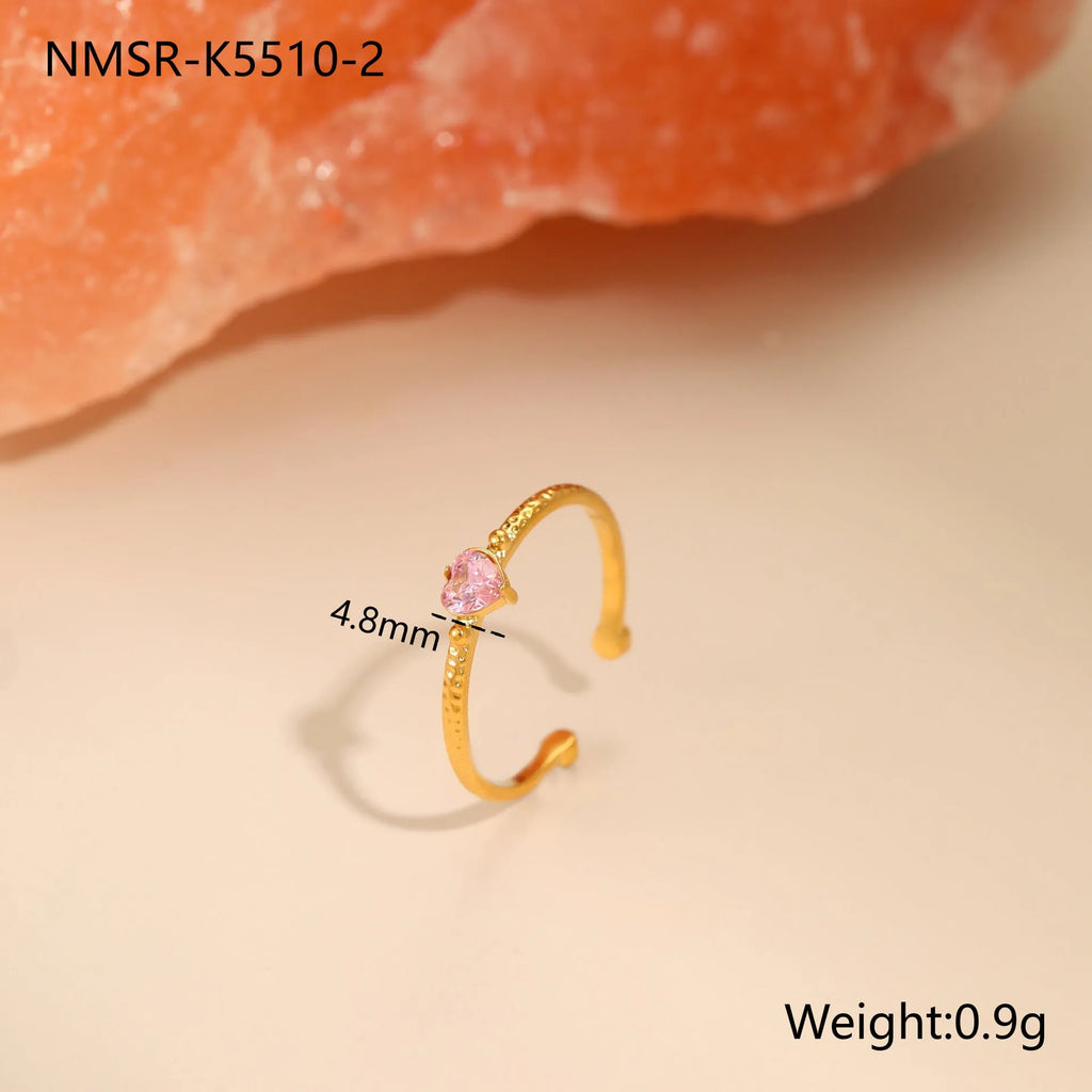 Open-ended geometric heart ring with a cubic zirconia stone on a silver-toned stainless steel band.