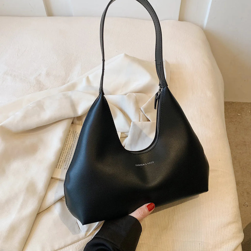 Brown retro PU shoulder handbag showing pillow shape, single strap, and organised interior with mobile phone pocket