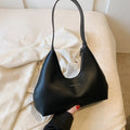 Brown retro PU shoulder handbag showing pillow shape, single strap, and organised interior with mobile phone pocket