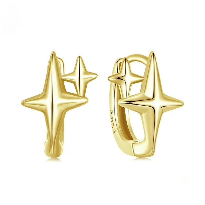 Minimalist star-shaped silver ear clips with oxidation finish and contemporary design details