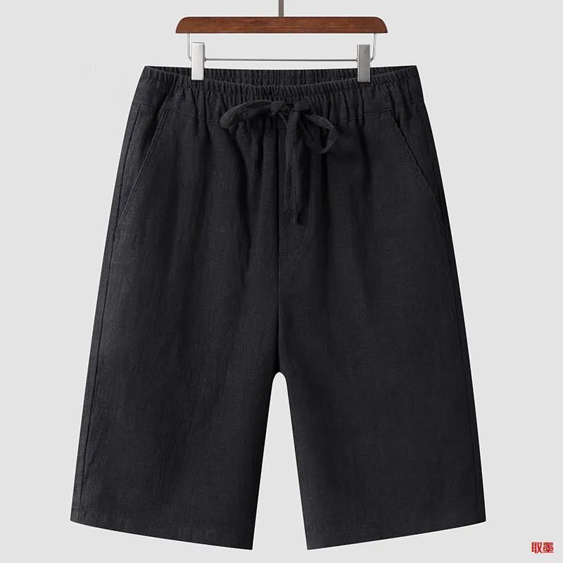 A pair of beige linen shorts for men with a loose, cropped fit and a mid-rise elasticated waistband.