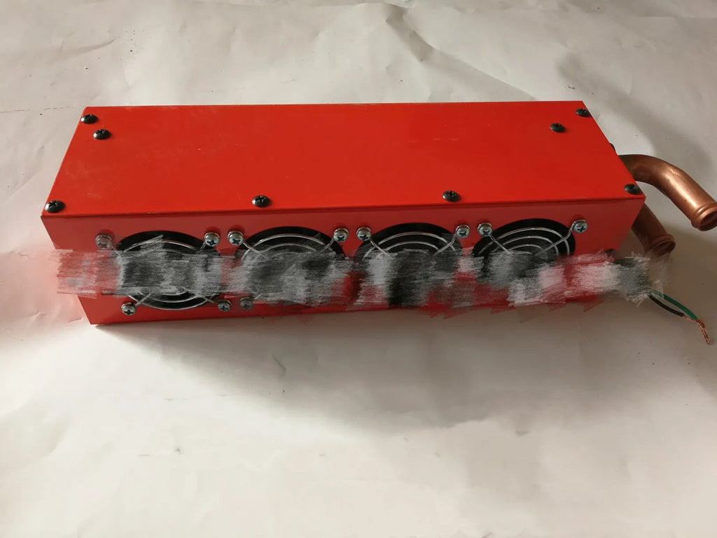 Compact metal 12V 24V car heater with four copper pipes and manual control, dimensions 34cm by 12cm by 8cm.